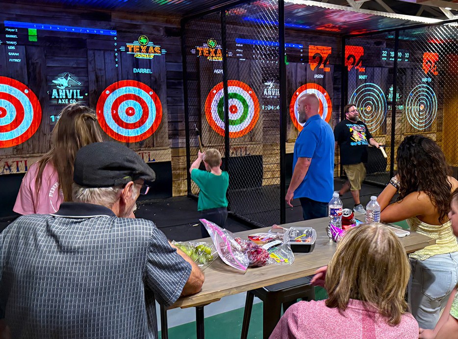 Guests watching axe throwing at Anvil Axe Co.